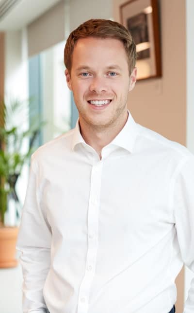 A man in white shirt smiling for the camera.